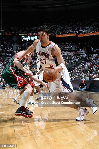 Zaza Pachulia of the Atlanta Hawks drives to the basket past Ersan Ilyasova of the Milwaukee Bucks in Game Seven of the Eastern Conference...