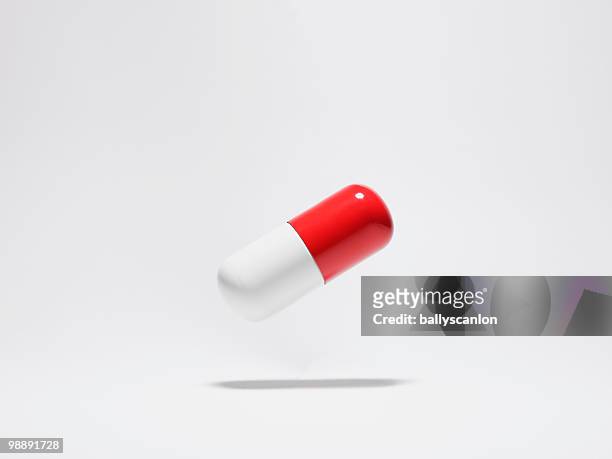 floating medical pill capsule. - capsule medicine ストックフォトと画像