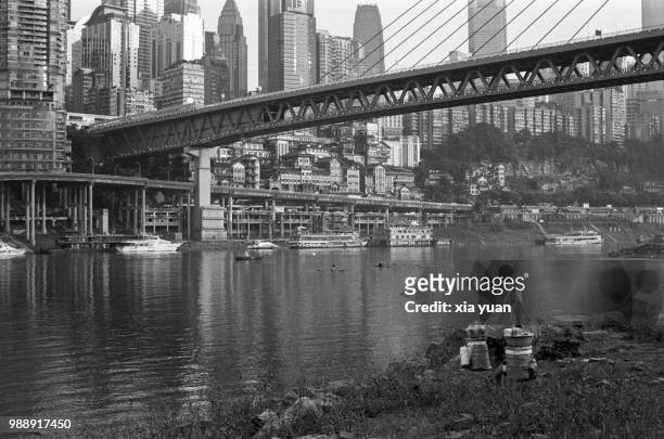 peddler carring his wares along river,chongqing,china - carrying pole stock pictures, royalty-free photos & images