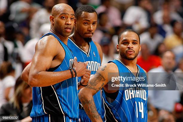 Vince Carter, Rashard Lewis and Jameer Nelson of the Orlando Magic look across the court in Game Four of the Eastern Conference Quarterfinals against...