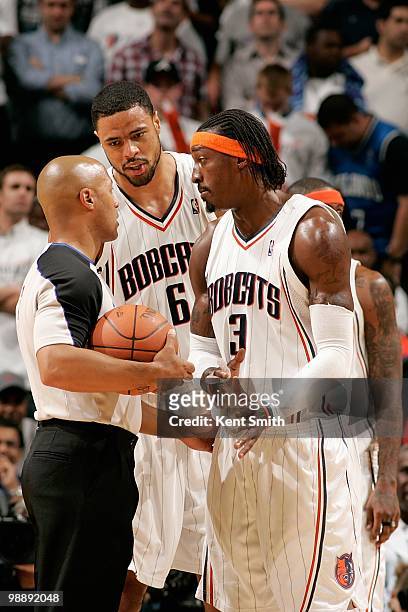 Tyson Chandler and Gerald Wallace of the Charlotte Bobcats talk to referee Marc Davis in Game Four of the Eastern Conference Quarterfinals against...