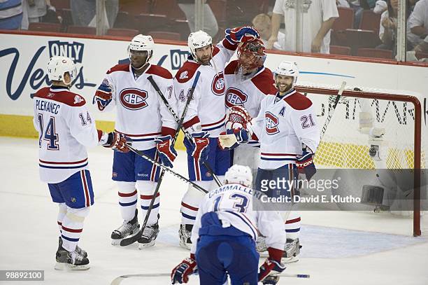 Montreal Canadiens goalie Jaroslav Halak , Brian Gionta , and Roman Hamrlik victorious after winning Game 2 vs Pittsburgh Penguins. Pittsburgh, PA...