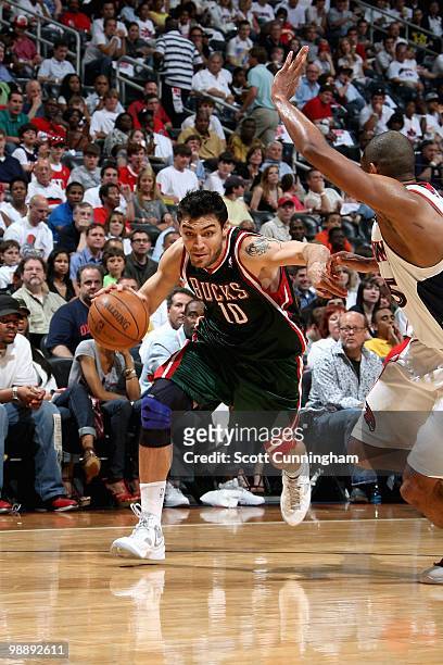 Carlos Delfino of the Milwaukee Bucks drives to the basket past Al Horford of the Atlanta Hawks in Game Seven of the Eastern Conference Quarterfinals...