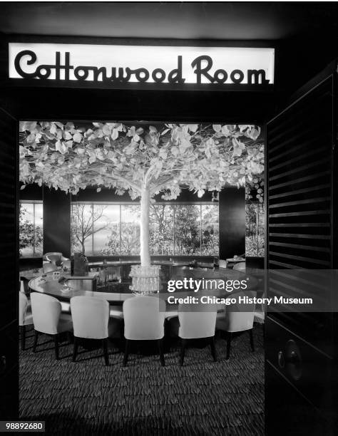 Interior view of the Blackstone Hotel, showing the entrance, with a �Cottonwood Room� sign above the doorway, and a large round table with chairs,...