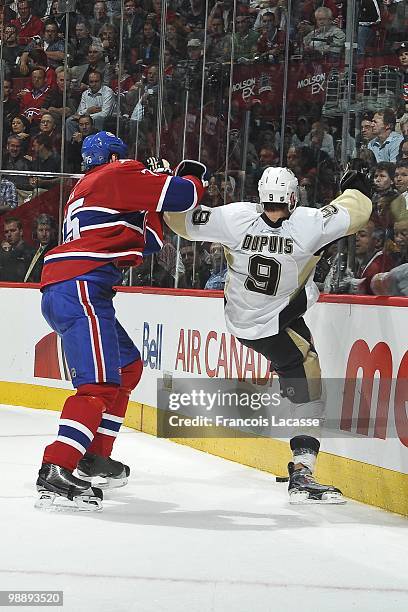 Hal Gill of Montreal Canadiens collides with Pascal Dupuis of the Pittsburgh Penguins in Game Three of the Eastern Conference Semifinals during the...