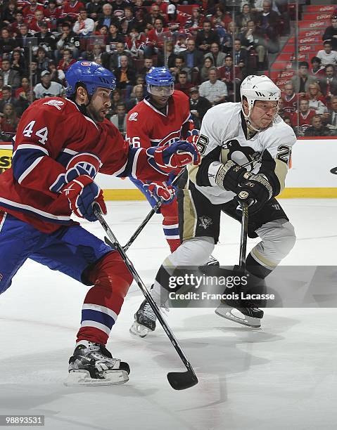 Roman Hamrlik of Montreal Canadiens battles to reach the puck with Ruslan Fedotenko of the Pittsburgh Penguins in Game Three of the Eastern...