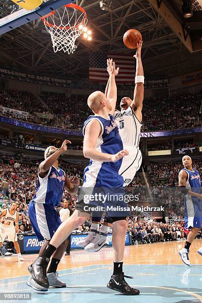 Carlos Boozer of the Utah Jazz shoots against Chris Kaman of the Los Angeles Clippers at EnergySolutions Arena on March 06, 2010 in Salt Lake City,...