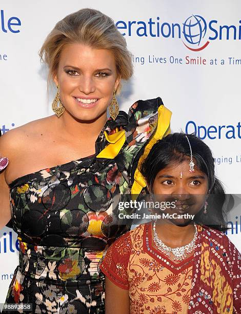 Jessica Simpson and Operation Smile patient Meena walk the red carpet during the Operation Smile Annual Gala at Cipriani, Wall Street on May 6, 2010...