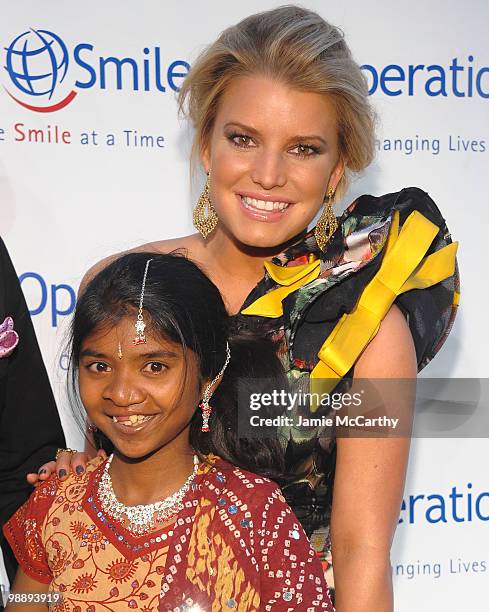 Jessica Simpson and Operation Smile patient Meena walk the red carpet during the Operation Smile Annual Gala at Cipriani, Wall Street on May 6, 2010...