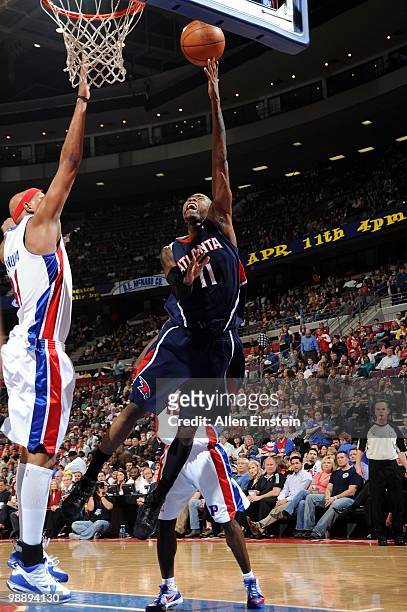 Jamal Crawford of the Atlanta Hawks puts a shot up against the Detroit Pistons during the game at the Palace of Auburn Hills on April 7, 2010 in...