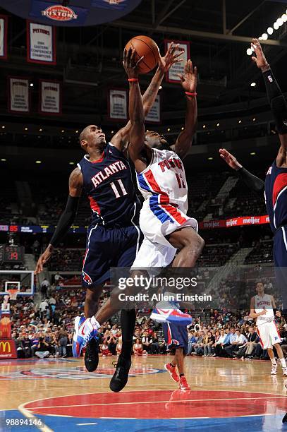 Will Bynum of the Detroit Pistons puts a shot up against Jamal Crawford of the Atlanta Hawks during the game at the Palace of Auburn Hills on April...