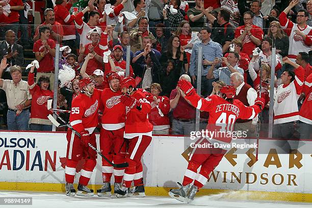 Johan Franzen of the Detroit Red Wings is congratulated by teammates Niklas Kronwall, Todd Bertuzzi and Henrik Zetterberg for his three goals on the...