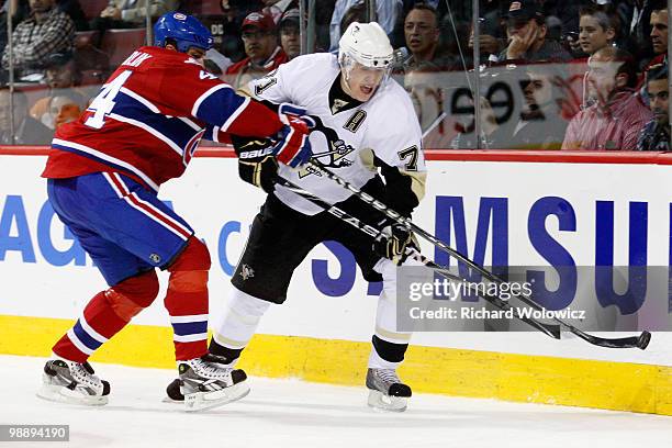 Evgeni Malkin of the Pittsburgh Penguins stick handles the puck while being defended by Roman Hamrlik of the Montreal Canadiens in Game Four of the...