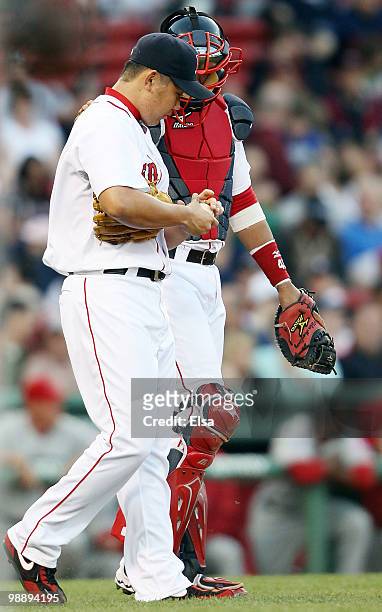Daisuke Matsuzaka and Victor Martinez of the Boston Red Sox talk on the way to the mound in the first inning against the Los Angeles Angels of...