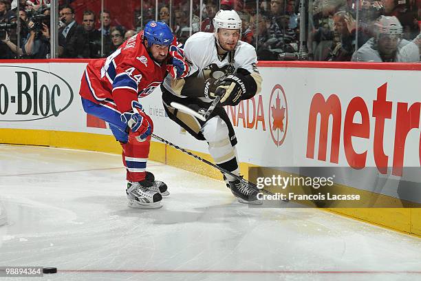 Roman Hamrlik of the Montreal Canadiens battles for the puck with Sergei Gonchar of the Pittsburgh Penguins in Game Four of the Eastern Conference...