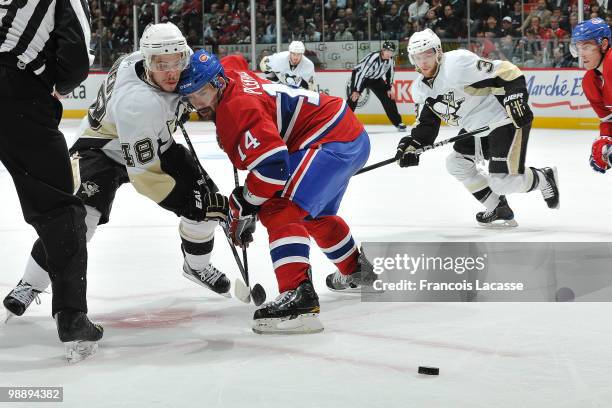 Tomas Plekanec of the Montreal Canadiens and Tyler Kennedy of the Pittsburgh Penguins collide during face off in Game Four of the Eastern Conference...