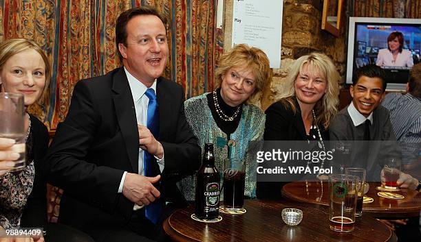 Conservative Party leader David Cameron enjoys a drink with supporters in a public house in his constituency on May 7, 2010 in Witney, England. After...