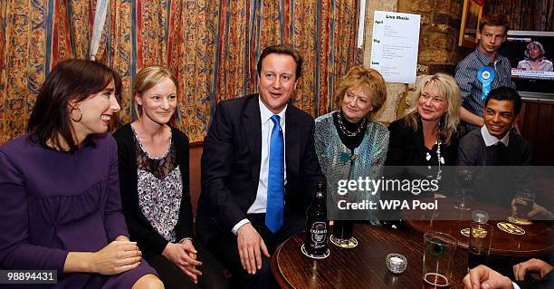 Conservative Party leader David Cameron and his wife Samantha enjoy a drink with supporters in a public house in his constituency on May 7, 2010 in...