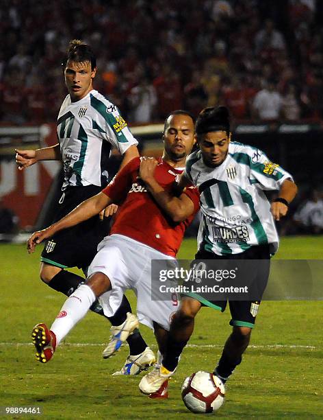 Soccer player Erviti of Banfield fights for the ball with Alecsandro of Internacional during their Libertadores Cup match at Beira-Rio stadium on May...