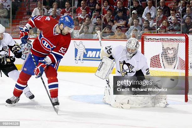 Mathieu Darche of the Montreal Canadiens deflects the puck wide of Marc-Andre Fleury of the Pittsburgh Penguins in Game Four of the Eastern...