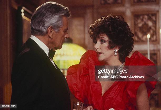 Actors John Forsythe and Joan Collins appear in a scene from an episode of the television show 'Dynasty,' Los Angeles, California, May 15, 1985.