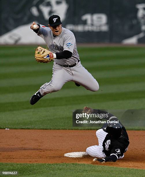 Juan Pierre of the Chicago White Sox slides into second base and forces Aaron Hill of the Toronto Blue Jays to leap and miss the double-play relay...