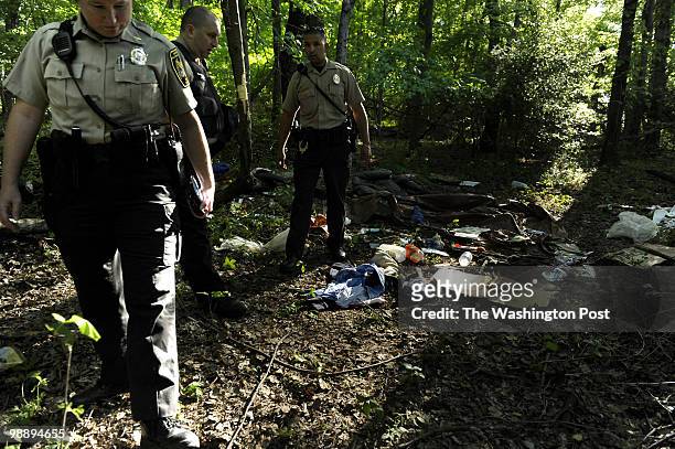 Maryland- National Capital Park Police Sgt. Lauryn McNeill, left, officers John Polk, center, and Caleb Garcia comb the scene where three juveniles...