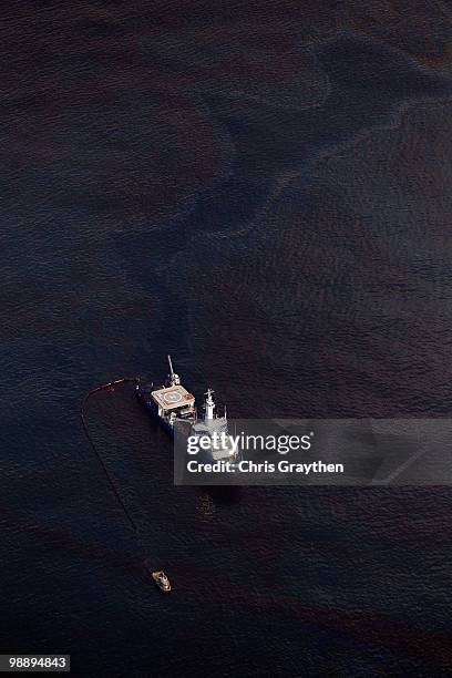 Responder boats skim oil off the surface of the water near the Deepwater Horizon wellhead on May 6, 2010 in the Gulf of Mexico. The well is still...