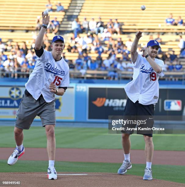 The 2018 Los Angeles Lakers NBA draft picks Sviatoslav Mykhailiuk and Moe Wagner throw out the ceremonial first pitch before the game between the Los...