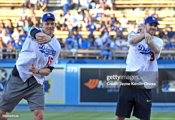 The 2018 Los Angeles Lakers NBA draft picks Sviatoslav Mykhailiuk and Moe Wagner throw out the ceremonial first pitch before the game between the Los...