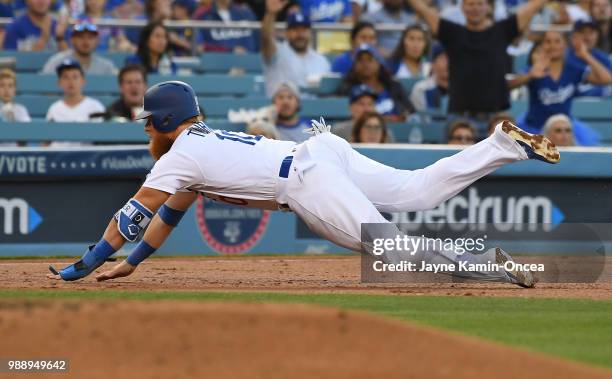 Justin Turner of the Los Angeles Dodgers is safe at third in the game against the Chicago Cubs at Dodger Stadium on June 27, 2018 in Los Angeles,...