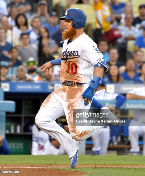 Justin Turner of the Los Angeles Dodgers is safe at home in the game against the Chicago Cubs at Dodger Stadium on June 27, 2018 in Los Angeles,...