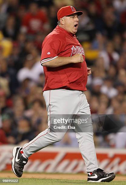 Manager Mike Scioscia of the Los Angeles Angels of Anaheim runs on the field to discuss a call in the fifth inning against the Boston Red Sox on May...