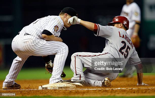 Adam LaRoche of the Arizona Diamondbacks slides safely into third base after hitting a triple in the fifth inning against the Houston Astros as third...