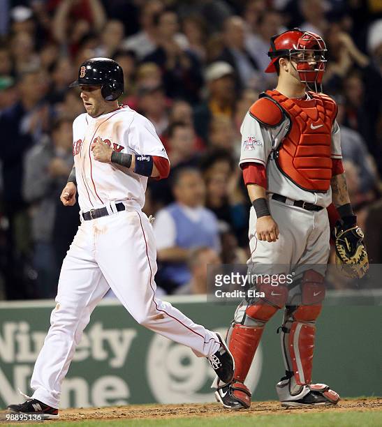 Dustin Pedroia of the Boston Red Sox scores in the fifth inning as Mike Napoli of the Los Angeles Angels of Anaheim defends on May 6, 2010 at Fenway...