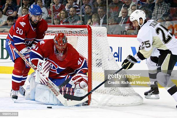 Jaroslav Halak of the Montreal Canadiens stops the puck on a wrap around attempt by Maxime Talbot of the Pittsburgh Penguins in Game Four of the...