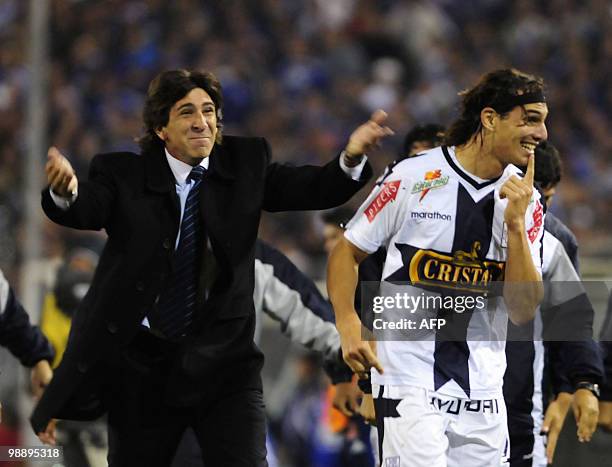 Alianza Lima's Jose Fernandez and his coach Gustavo Costas celebrate after scoring against Universidad de Chile during their Copa Libertadores 2010...