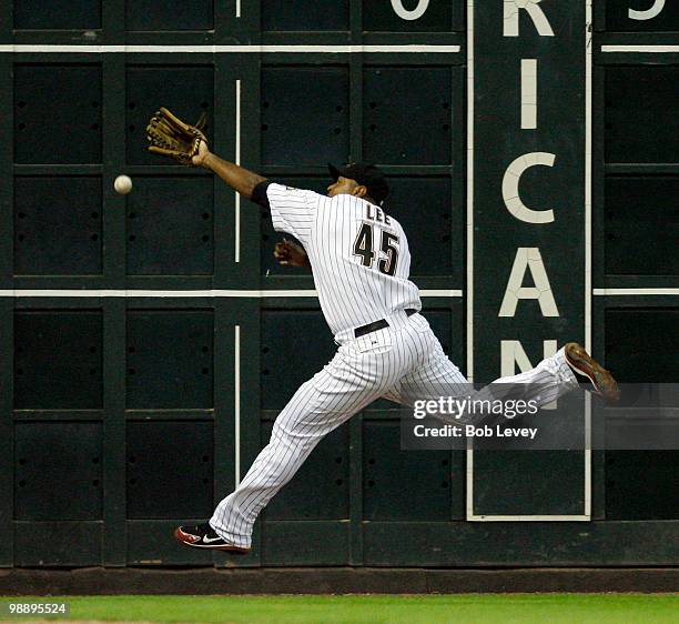 Left fielder Carlos Lee of the Houston Astros can't reach the ball hit by Adam LaRoche of the Arizona Diamondbacks in the fifth inning at Minute Maid...