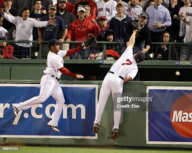 Drew and Darnell McDonald of the Boston Red Sox are unable to catch the home run hit by Mike Napoli of the Los Angeles Angels of Anaheim on May 6,...