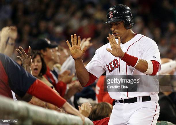 Victor Martinez of the Boston Red Sox celebrates with teammates in the dugout after he scored in the sixth inning against the Los Angeles Angels of...