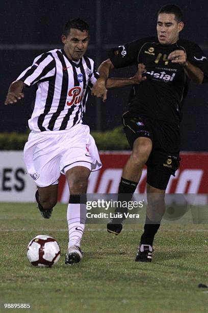 John Valencia of Once Caldas fights for the ball with Sergio Aquino of Libertad during a match as part of the Libertadores Cup 2010 at Defensores del...