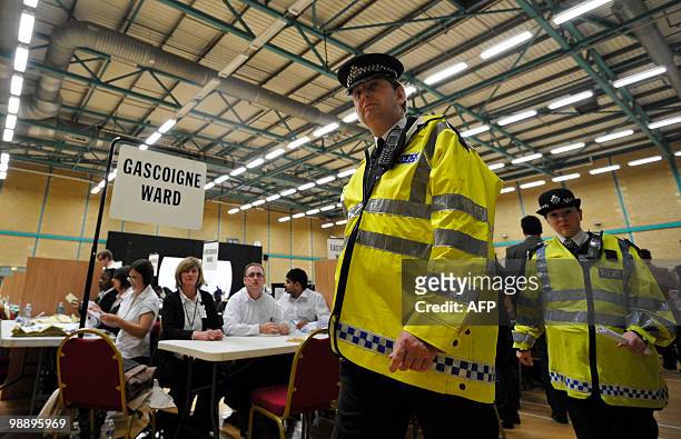 Police officers patrol the area where ballots will be counted where, British National Party Leader , and candidate for Barking, Nick Griffin is...