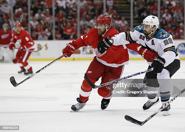 Henrik Zetterberg of the Detroit Red Wings tries to get round Dan Boyle of the San Jose Sharks during Game Four of the Western Conference Semifinals...