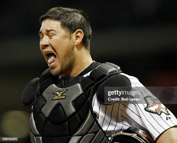 Catcher Humberto Quintero of the Houston Astros makes a face after being interfered with by Adam LaRoche of the Arizona Diamondbacks in the seventh...