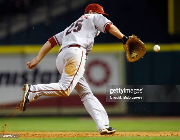 First baseman Adam LaRoche of the Arizona Diamondbacks makes a backhand play on a ball hit by Michael Bourn of the Houston Astros at Minute Maid Park...