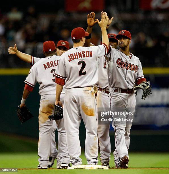 Kelly Johnson of the Arizona Diamondbacks gives Chris young a high five after the final out against the Houston Astros at Minute Maid Park on May 6,...