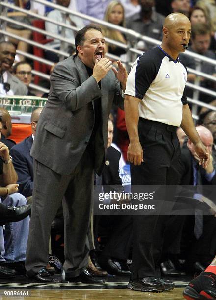 Head coach Stan Van Gundy of the Orlando Magic yells out to his team behind official Marc Davis while facing the Atlanta Hawks in Game Two of the...