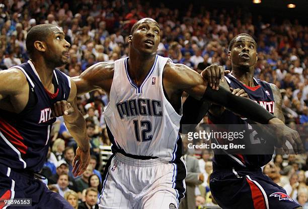 Al Horford and Marvin Williams of the Atlanta Hawks fight for position with Dwight Howard of the Orlando Magic in Game Two of the Eastern Conference...