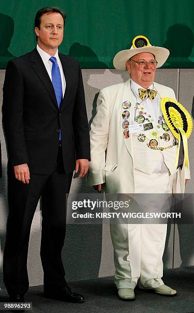 British opposition Conservative party Leader David Cameron stands with stands with Alan Hope of the Monster Raving Looney William Hill Party, during...