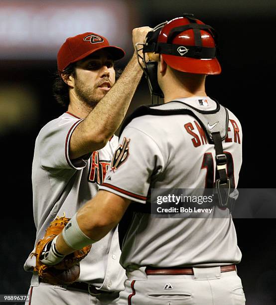 Pitcher Dan Haren of the Arizona Diamondbacks gets a high five from catcher Chris Snyder after the final out against the Houston Astros at Minute...